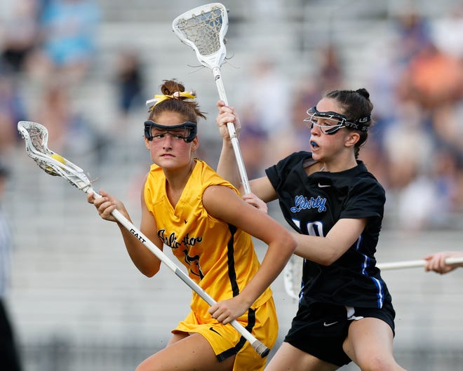 Apr 16, 2024; Upper Arlington, Ohio, USA; Upper Arlington’s Lilly Boyle (13) is defended by Olentangy Liberty’s Eloise Pohmer (10) during the high school girls lacrosse game at Upper Arlington High School Marv Moorehead Memorial Stadium. Upper Arlington won 9-8. Mandatory Credit: Graham Stokes-The Columbus Dispatch