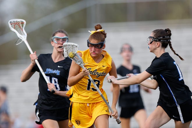 Apr 16, 2024; Upper Arlington, Ohio, USA; Upper Arlington’s Lilly Boyle (13) moves with the ball during the high school girls lacrosse game against Olentangy Liberty at Upper Arlington High School Marv Moorehead Memorial Stadium. Upper Arlington won 9-8. Mandatory Credit: Graham Stokes-The Columbus Dispatch