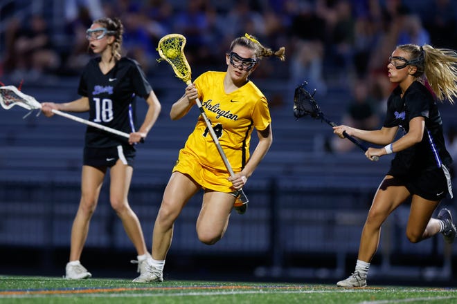 Apr 16, 2024; Upper Arlington, Ohio, USA; Upper Arlington’s Bethany Smith (14) moves with the ball during the high school girls lacrosse game against Olentangy Liberty at Upper Arlington High School Marv Moorehead Memorial Stadium. Upper Arlington won 9-8. Mandatory Credit: Graham Stokes-The Columbus Dispatch