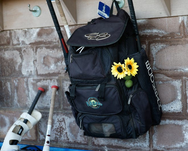 Apr 22, 2024; Powell, Ohio, USA; Sunflowers decorate a bag in the Olentangy Liberty dugout before the high school softball game against Hilliard Bradley at Olentangy Liberty High School. Hilliard Bradley won 3-2. Mandatory Credit: Graham Stokes-The Columbus Dispatch