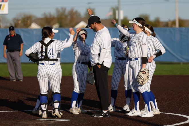 Apr 22, 2024; Powell, Ohio, USA; Olentangy Liberty's head coach Ty Kashmiry with his players during a pause in play during the high school softball game against Hilliard Bradley at Olentangy Liberty High School. Hilliard Bradley won 3-2. Mandatory Credit: Graham Stokes-The Columbus Dispatch